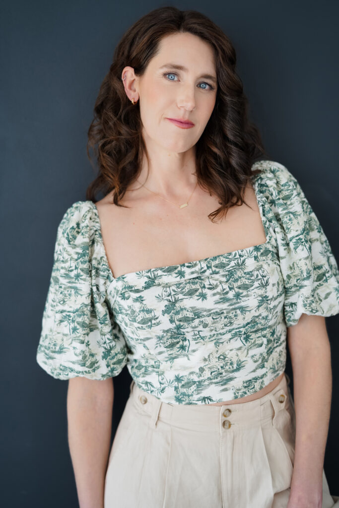 A woman poses with a blue background